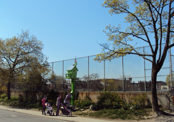 People looking at birdhouse