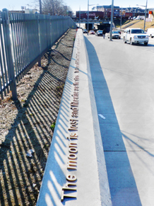 Poetry imbedded in concrete along street.