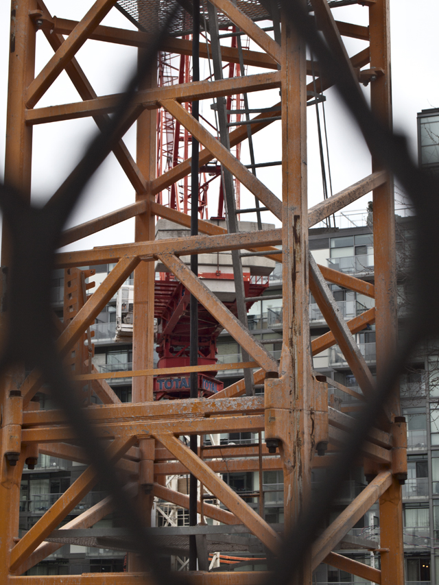 Through a link in the fence.