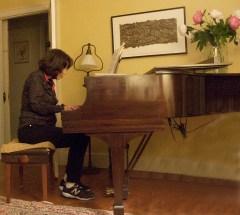 Playing piano and singing.