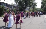 Bridal party walking down the middle of the street.