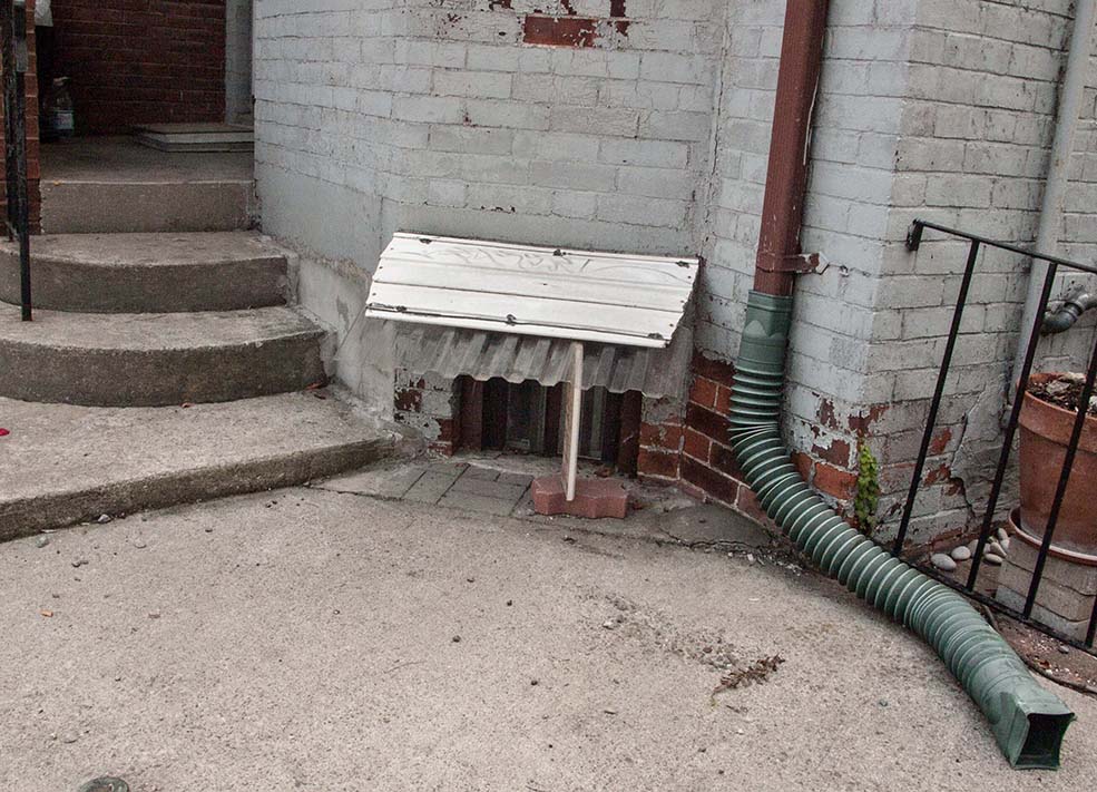 Basement apartment with window awning.