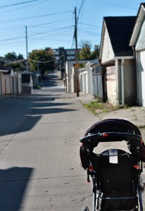 Baby stroller in back lane.