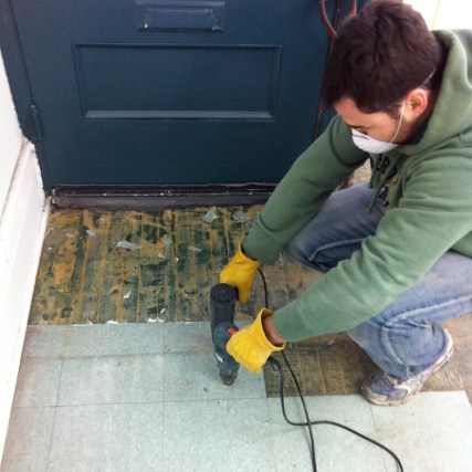 Ripping up old floor tiles at Boxcar Social.
