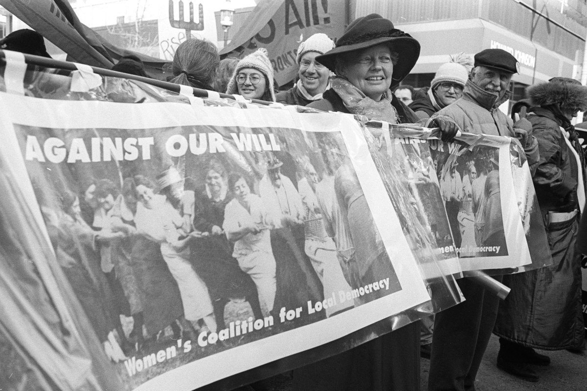 Banner held by marchers "Against Our Will".