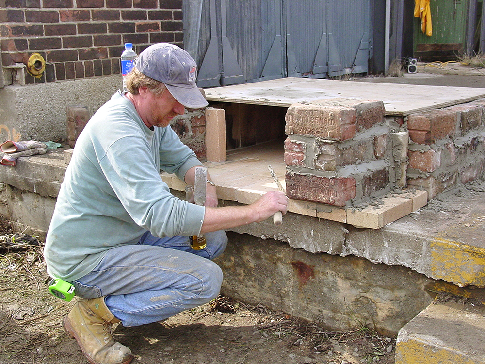 Peter building the pizza oven.