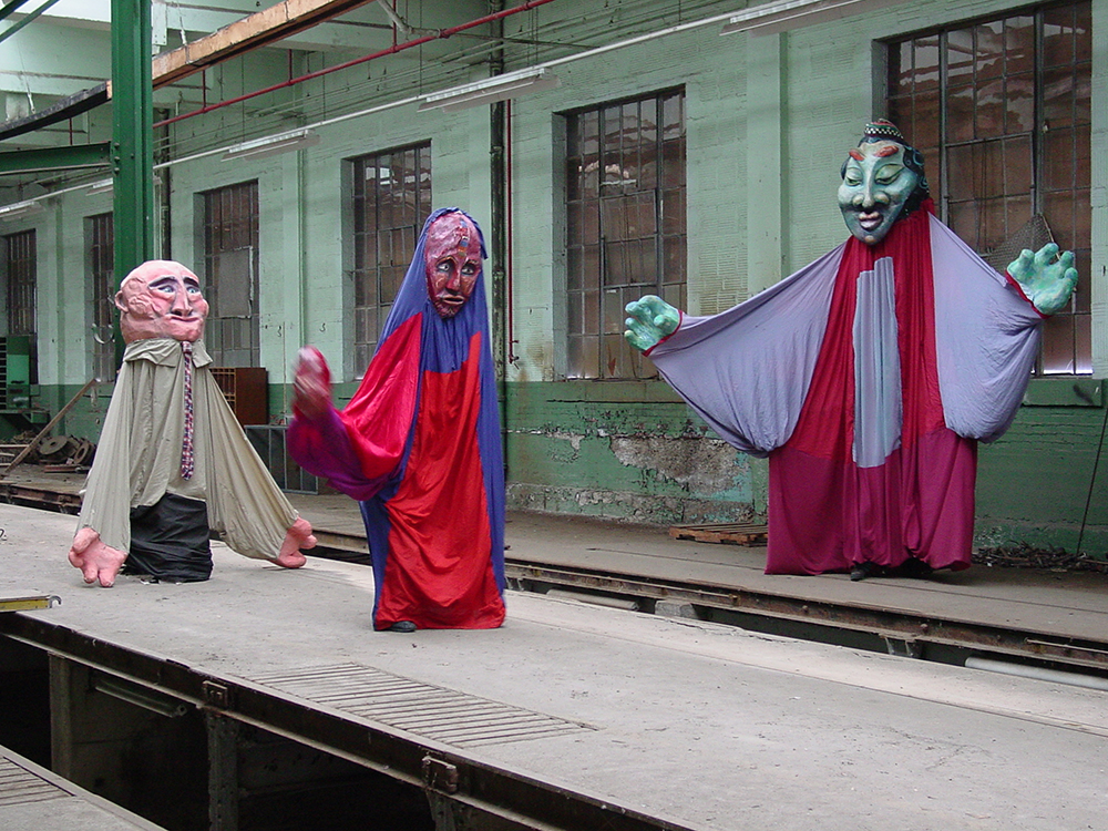 Giant puppets inside Wychwood barns.