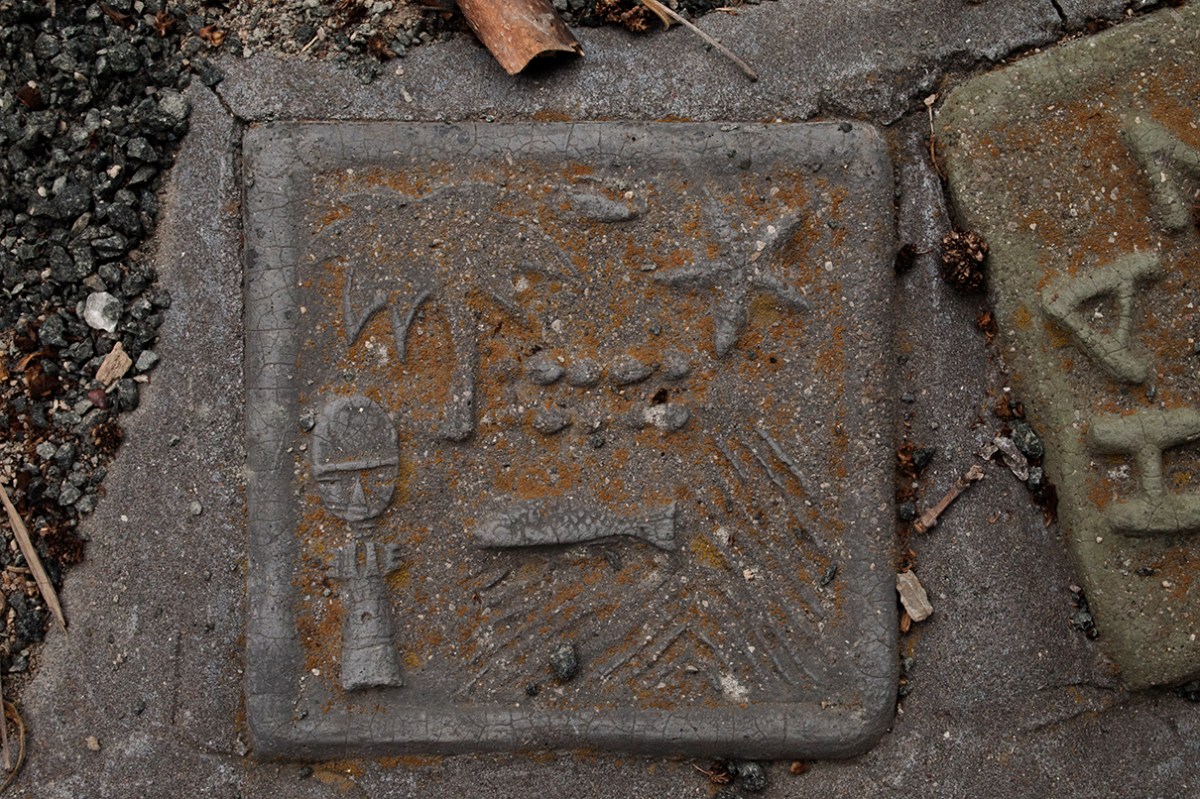African figure and fish tile.