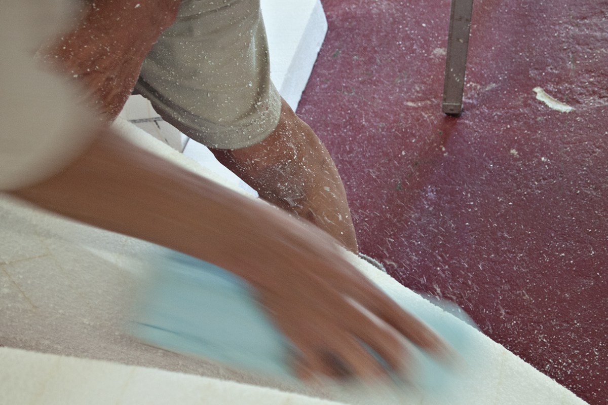 Hands sanding sculpture.