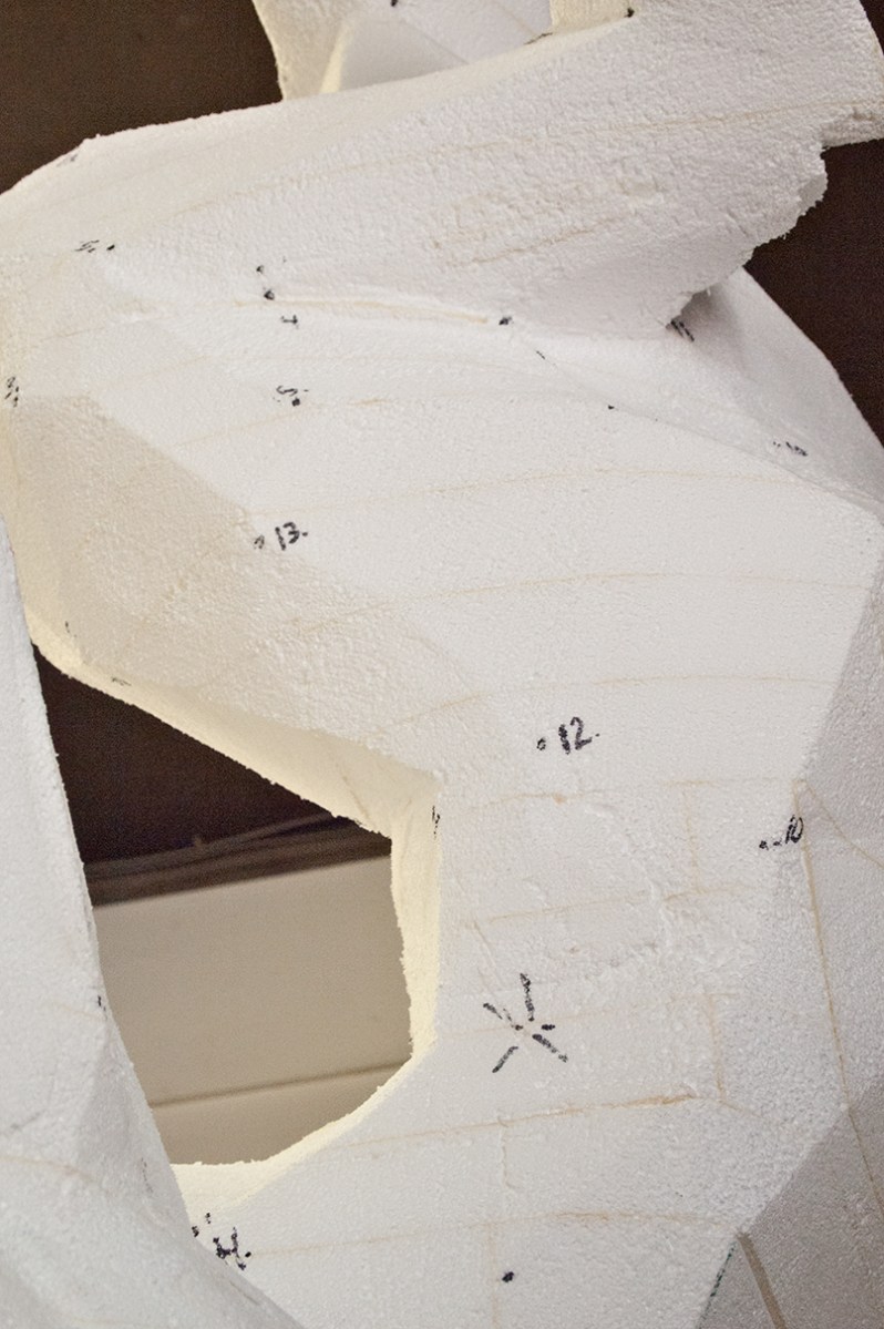 Sculture with markings for measurement.