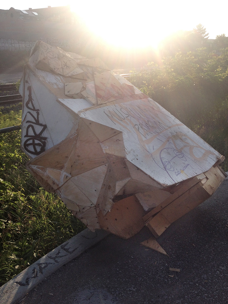 Sculpture tipped over up close.