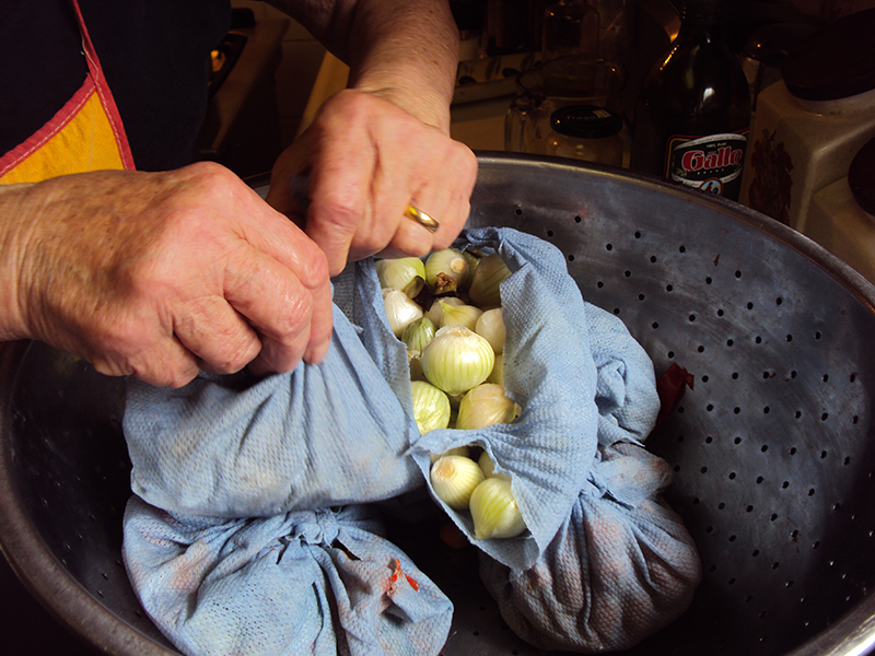 Tying packets of vegetables.