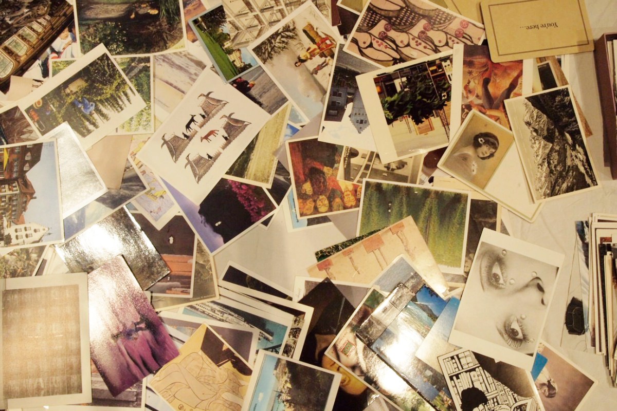 Table piled with postcards.