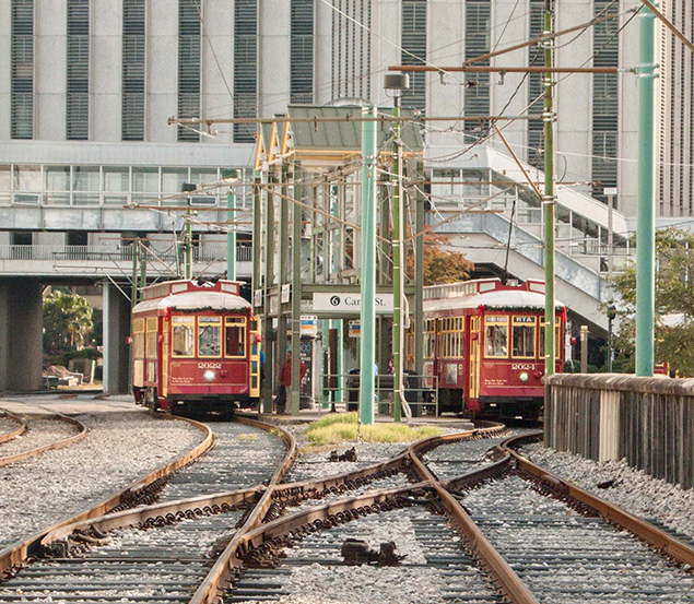 Two New Orleans streetcars at a stop.