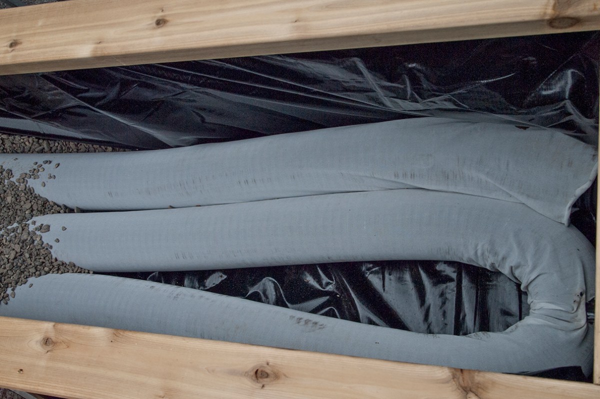 Weeping tile for planter water reservoir.