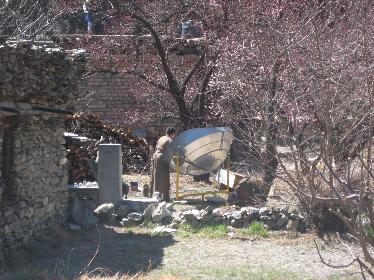 Nepal woman using solar cooker.
