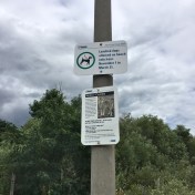 Signs about dogs and coyotes.