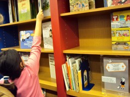 Ibby child taking book