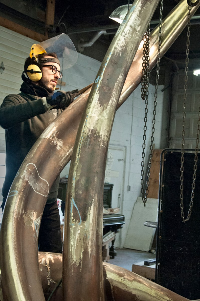 Polishing bronze forms.