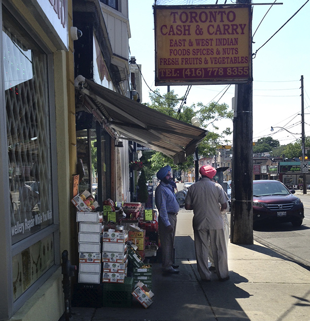 Sikh men standing outside store.