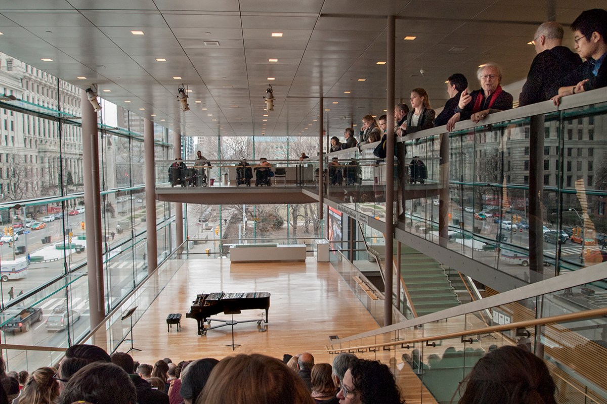 Audience standing at upper level.