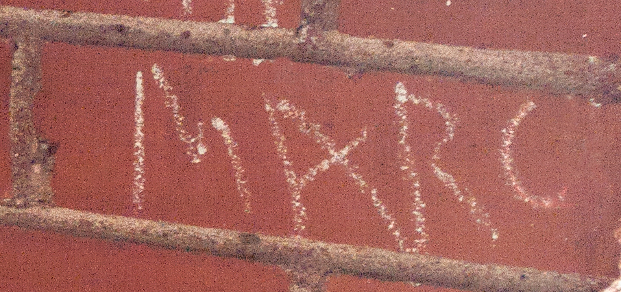 Brick with the name Marc chalked on it