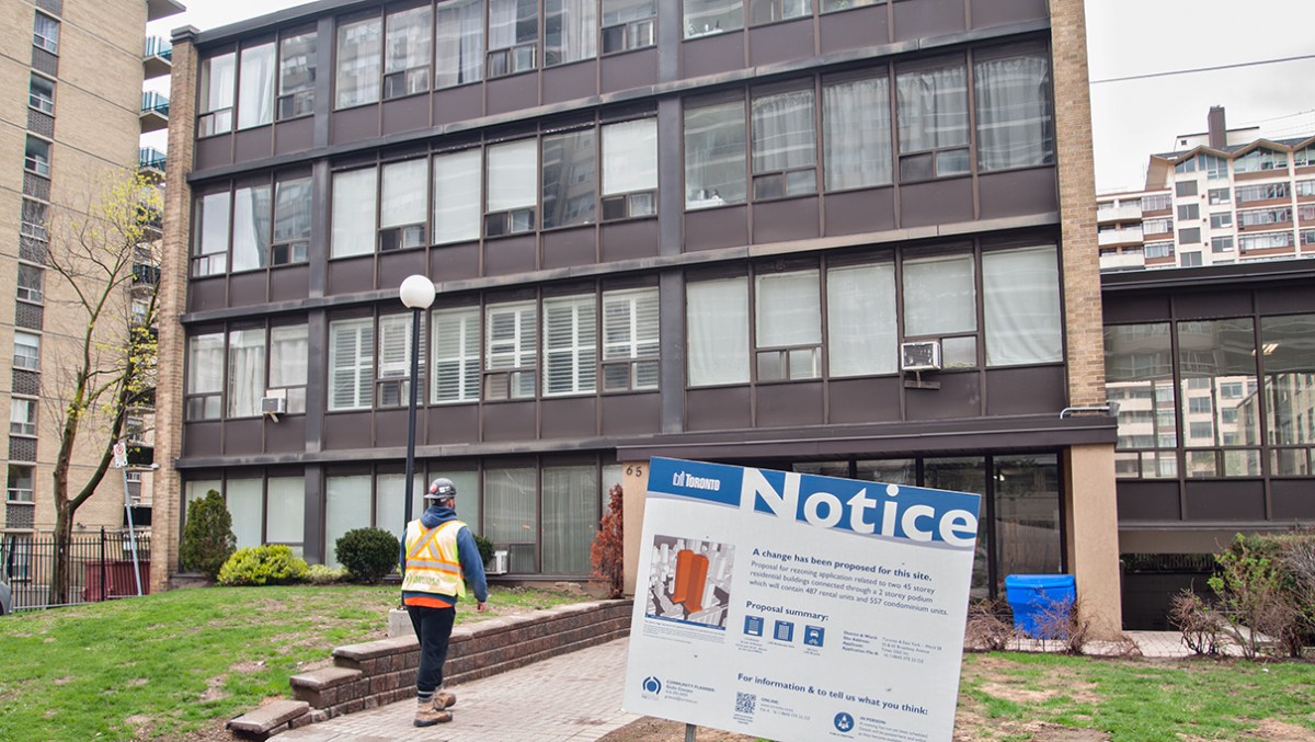 low rise apartment building with posted notice.