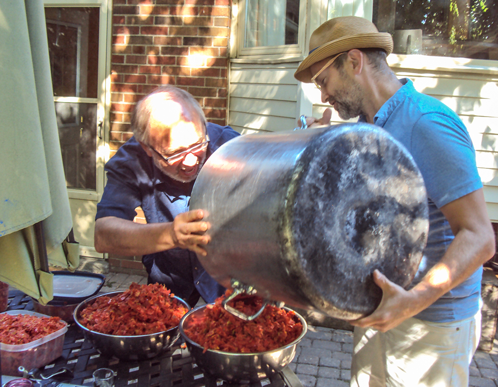 Joe and Mike Layton dumping out tomato skins.