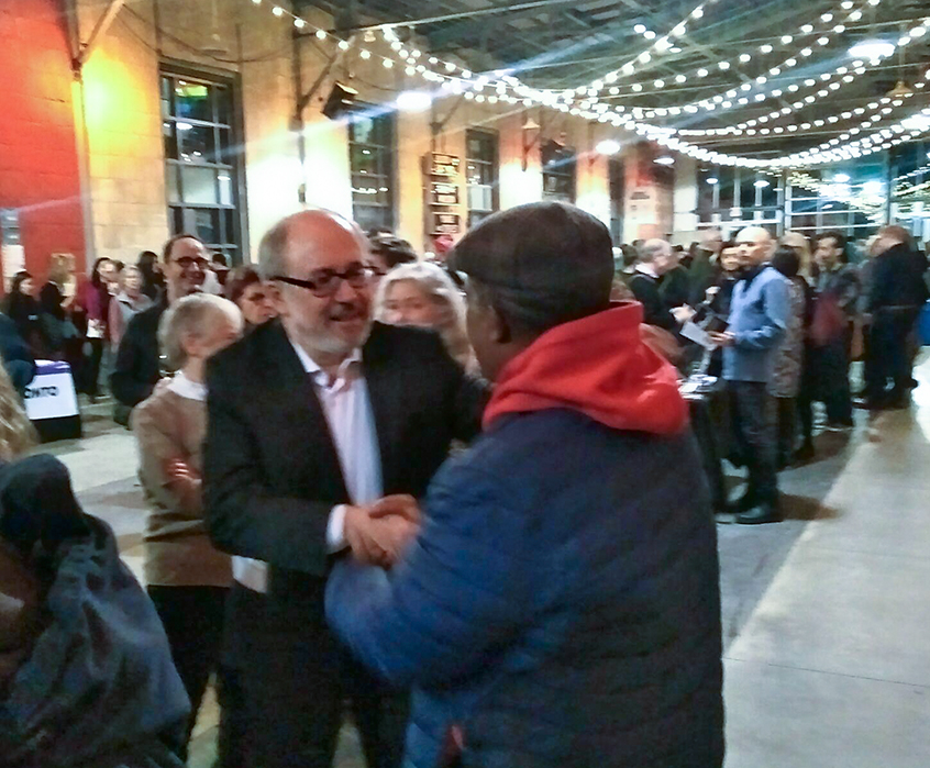 Joe Mihevc greeting supporters at party.